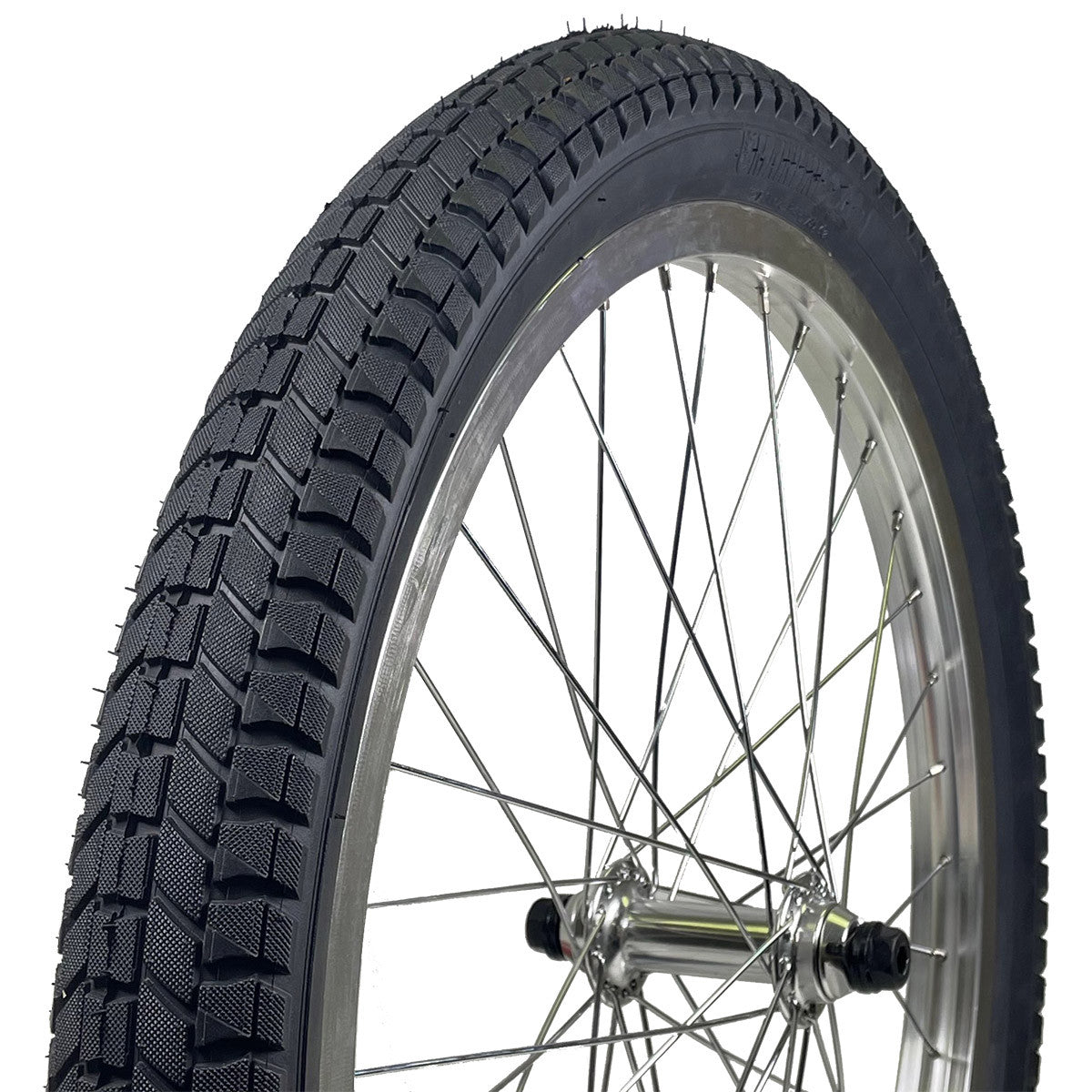 A black BMX tire with a wire bead and a tread pattern, mounted on a wheel.
