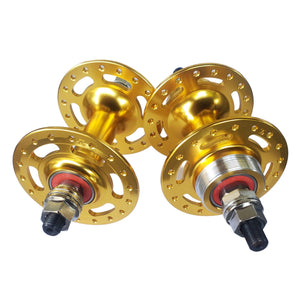 Two gold bicycle hubs on a white background