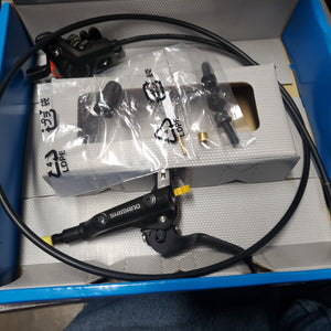 Bicycle brake components on a white box with a blue border