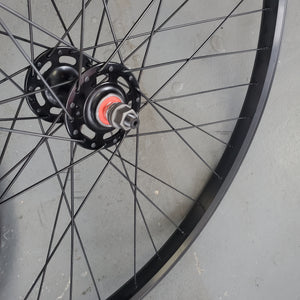 Close-up of a bicycle wheel hub on a gray surface