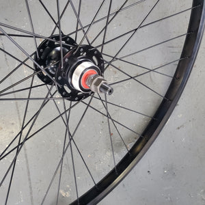 Close-up of a bicycle wheel hub on a concrete surface