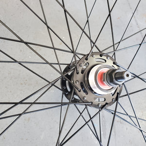 Close-up of a bicycle wheel hub on a concrete surface