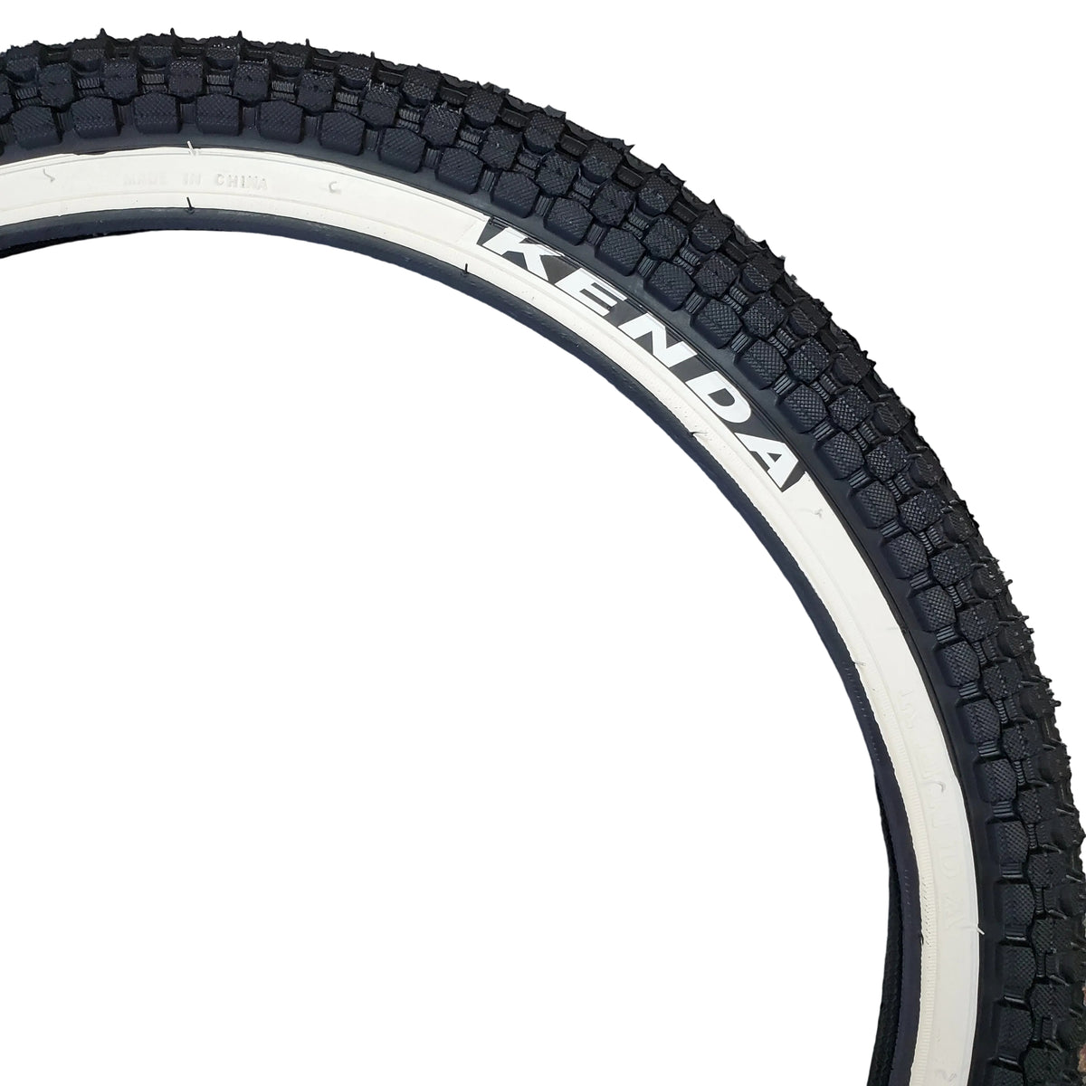 Close-up of a bicycle tire with 'Kenda' branding on a textured surface.