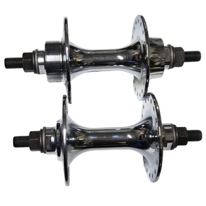Two metallic hub bearings on a white sheet of paper with a metal surface background