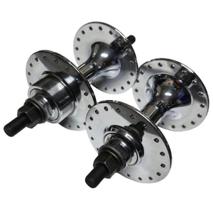 Bicycle hubs on a white surface with a blurred background