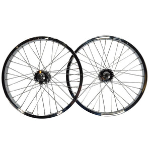 Two bicycle wheels with black rims and silver spokes on a light gray background