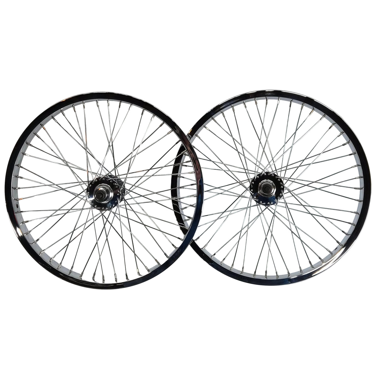 Two bicycle wheels mounted on a white wall