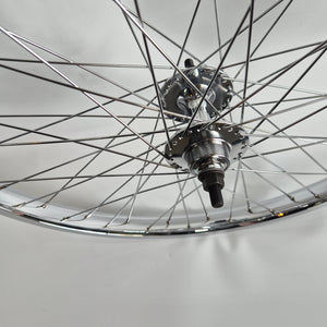 Close-up of a bicycle wheel hub on a gray background