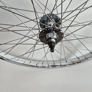 Close-up of a bicycle wheel hub on a light gray background