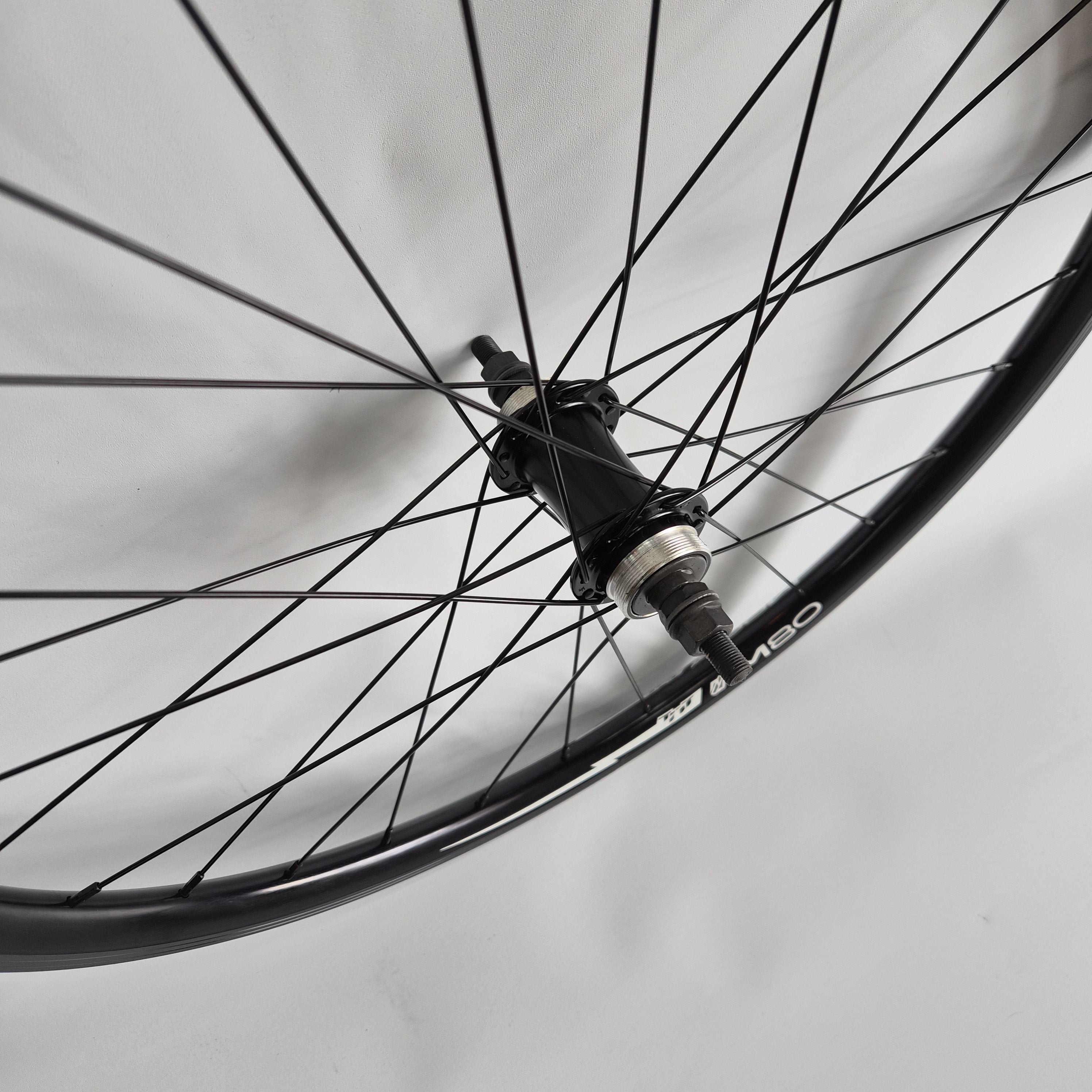 Close-up of a bicycle wheel with a blurred background