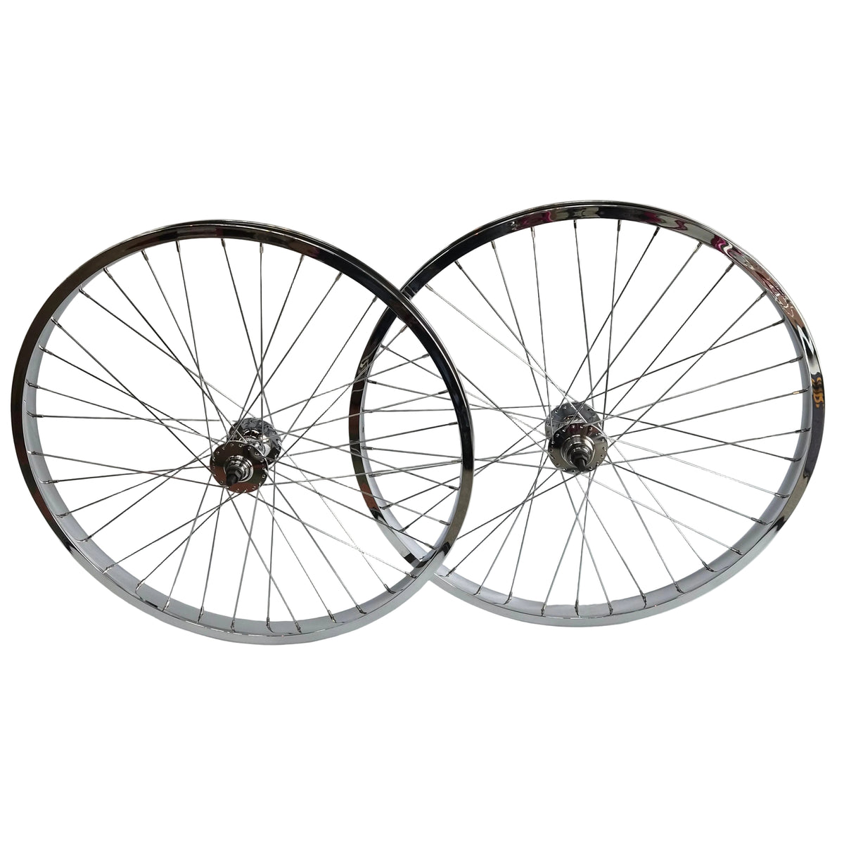 Two bicycle wheels stacked against a white wall