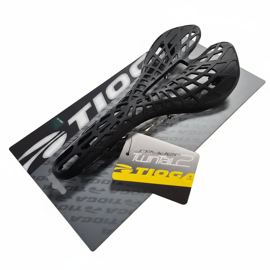 Black bicycle seat on a white surface with a brand card underneath