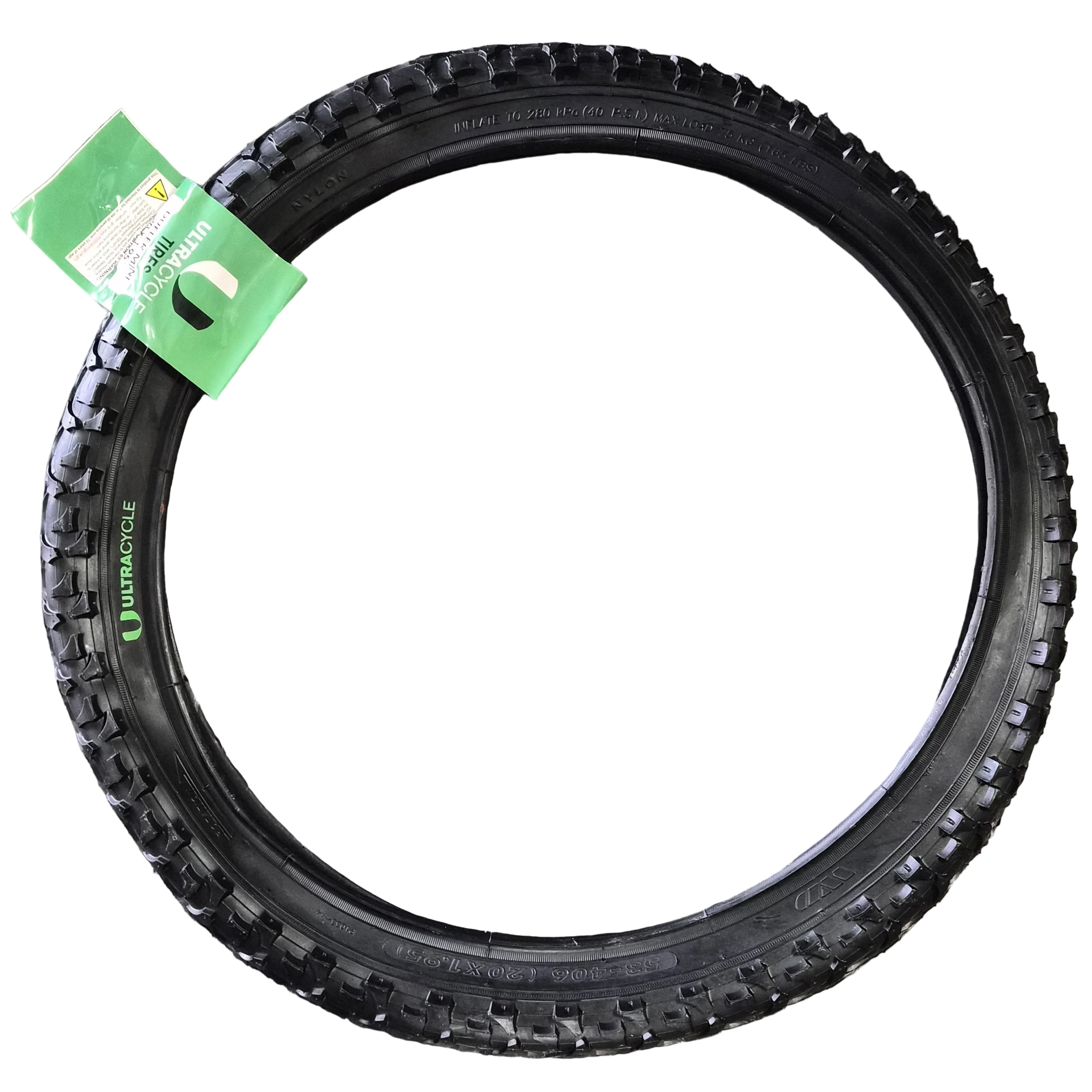 Black tire with a green tag on a concrete surface