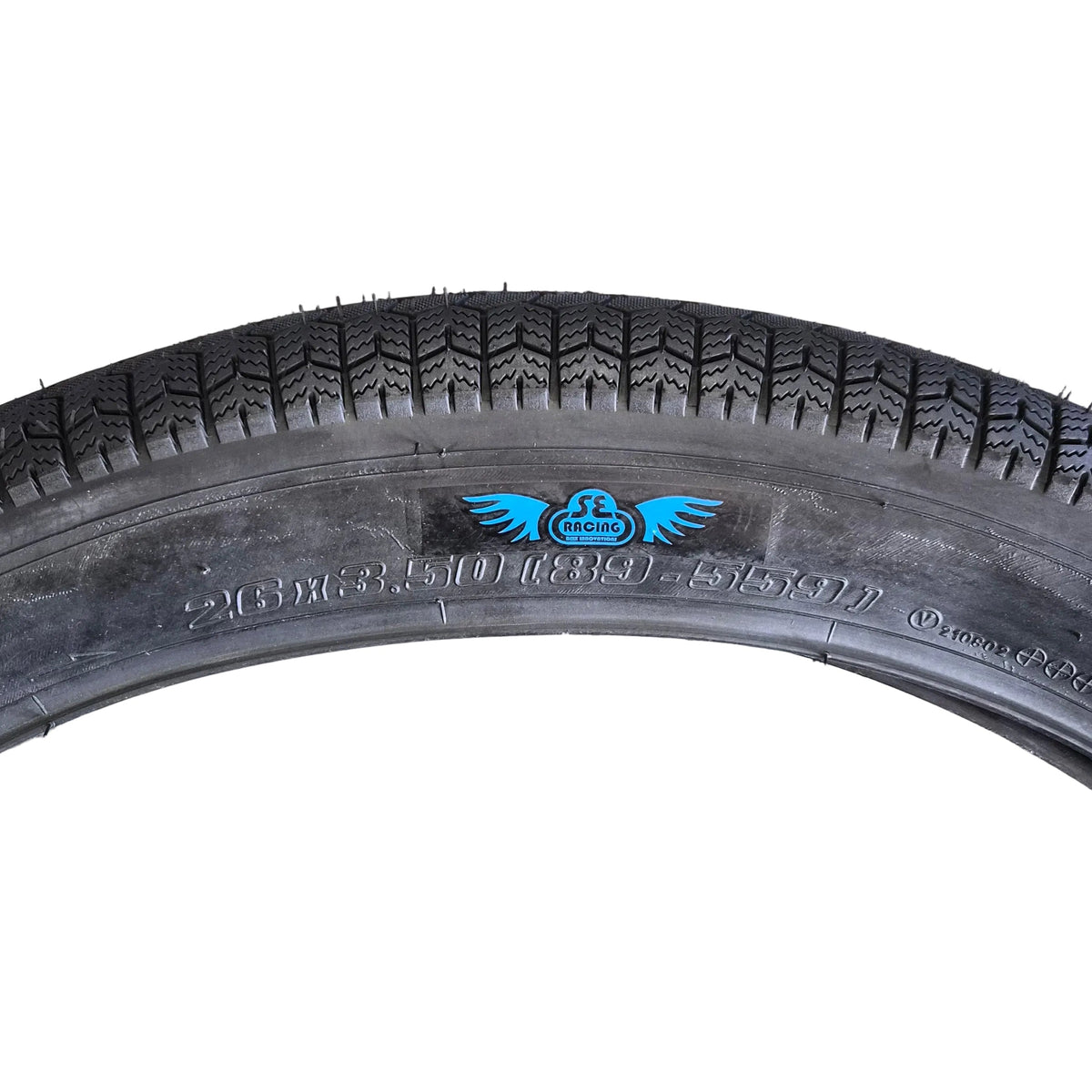 Black tire with a blue logo on a concrete surface