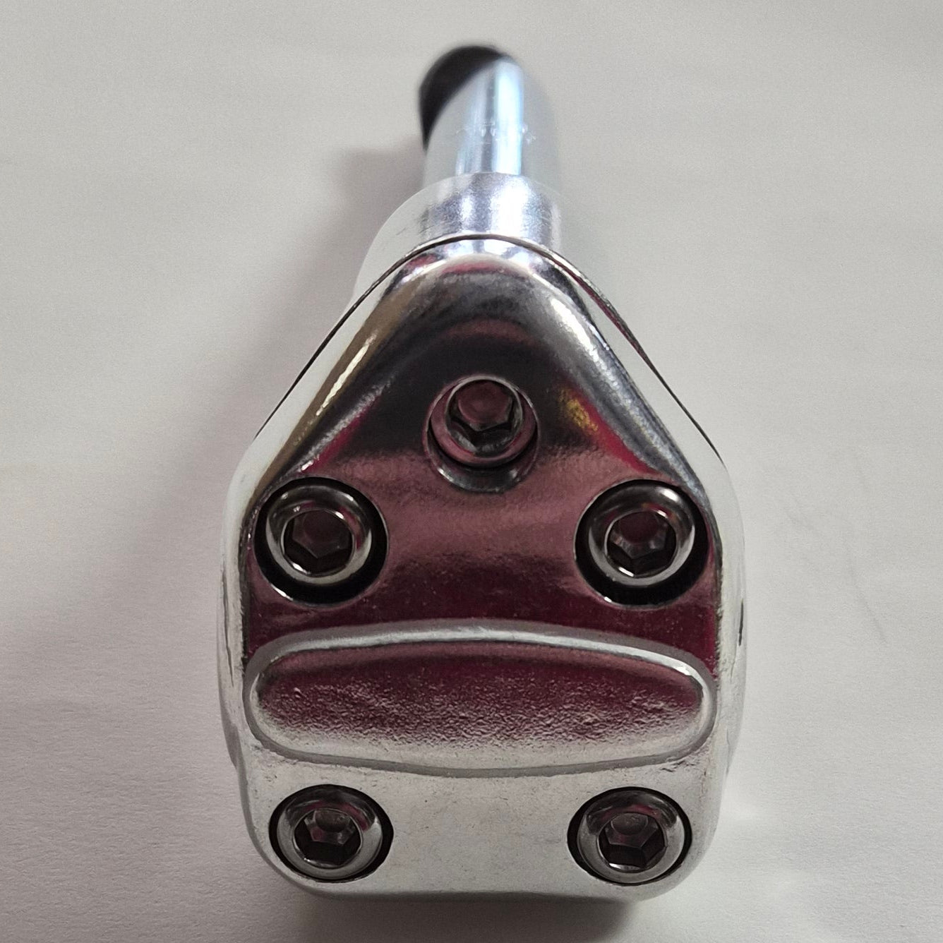 Metallic exhaust tip on a white background