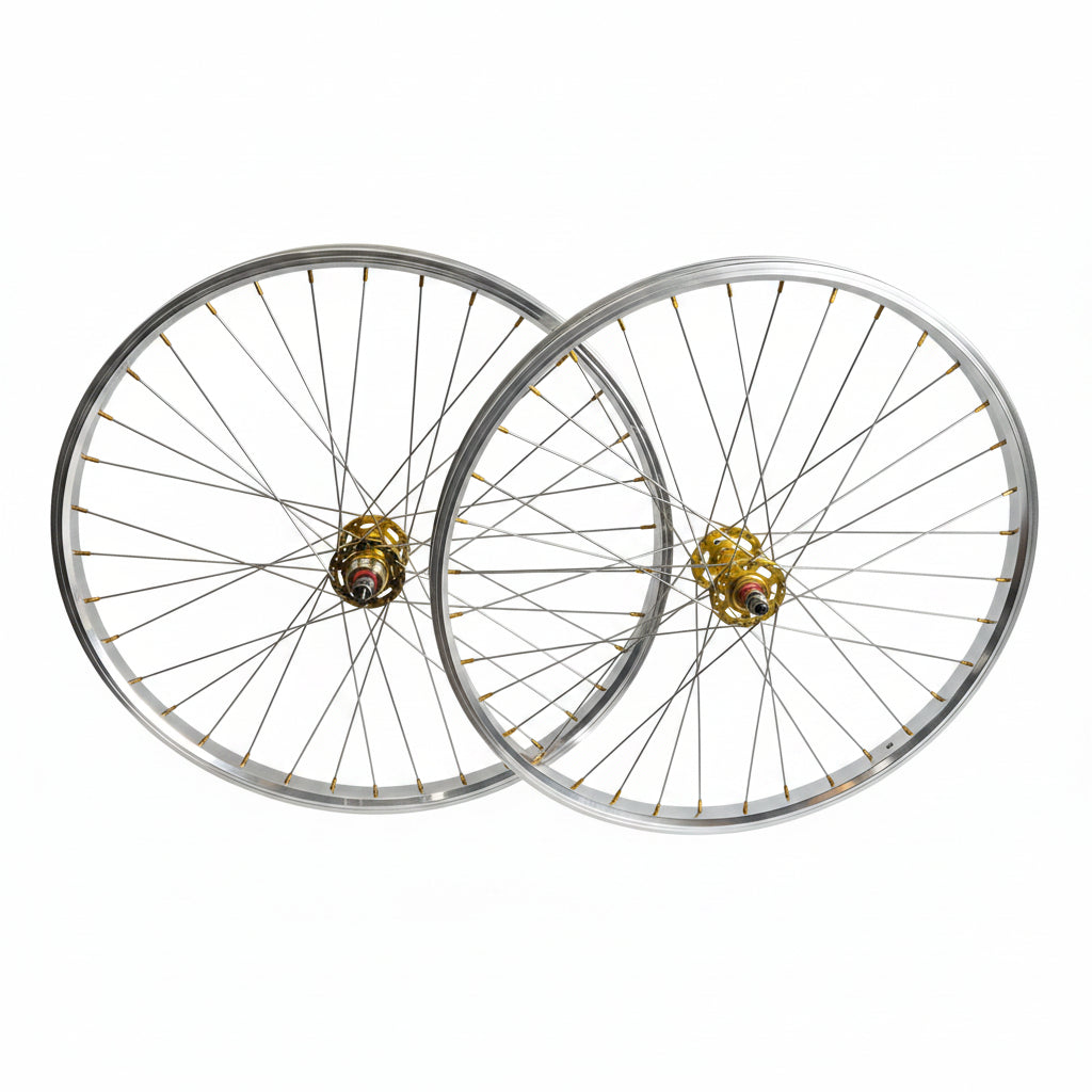 Two bicycle wheels with silver rims and spokes, featuring gold-colored hub centers, displayed against a plain light gray background.
