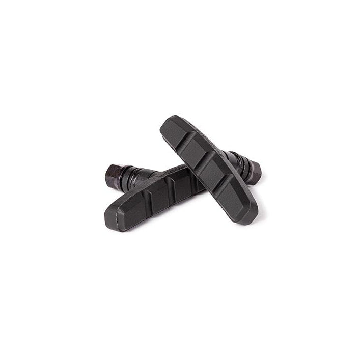 Two black bicycle brake pads on a white background