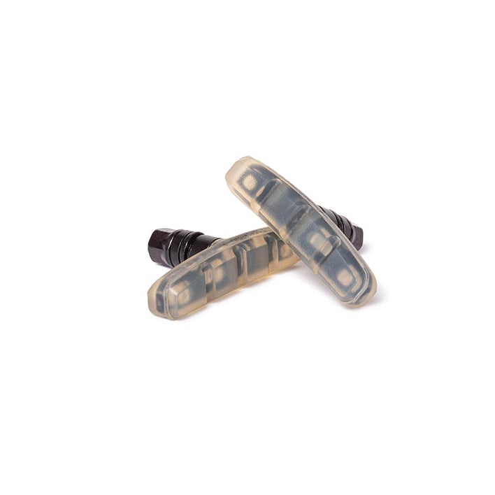 Pair of clear bicycle brake pads on a white background