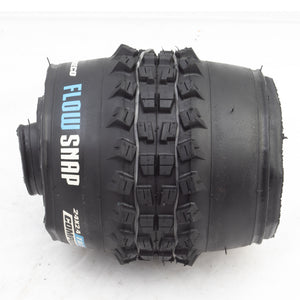 Black tire with 'Flow Snap' branding on a white background