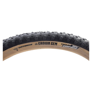 Bicycle tire with tread pattern and brand name on a white background