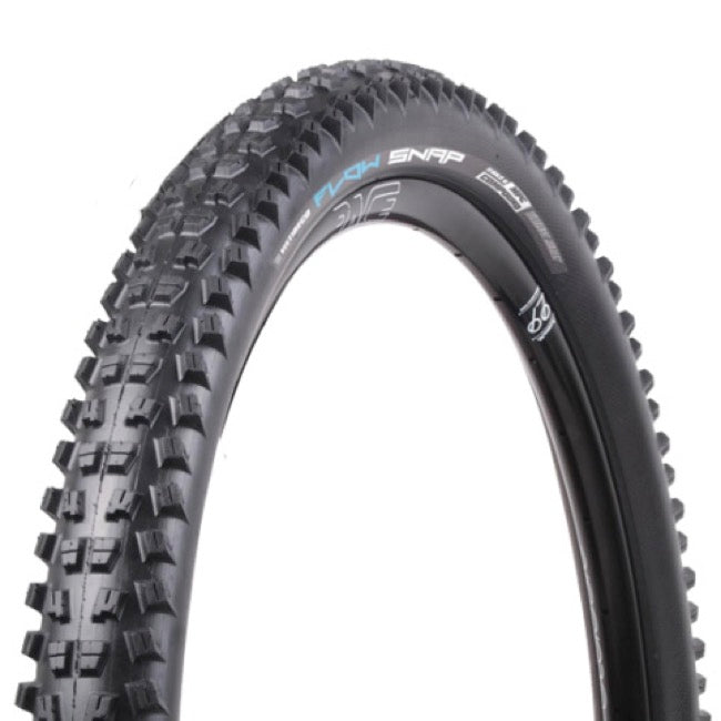 Close-up of a black bicycle tire with tread pattern on a white background