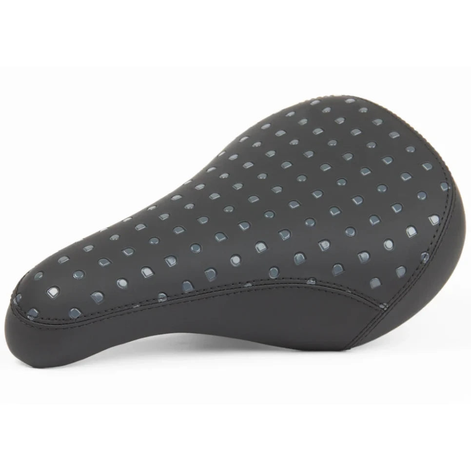Black bicycle seat with perforated design on a white background
