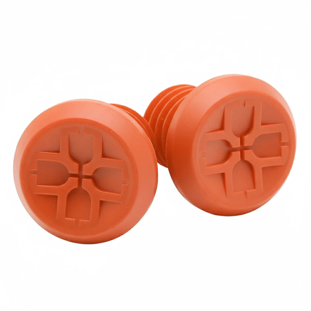 Two orange plastic plugs with a star-shaped cutout on a white background