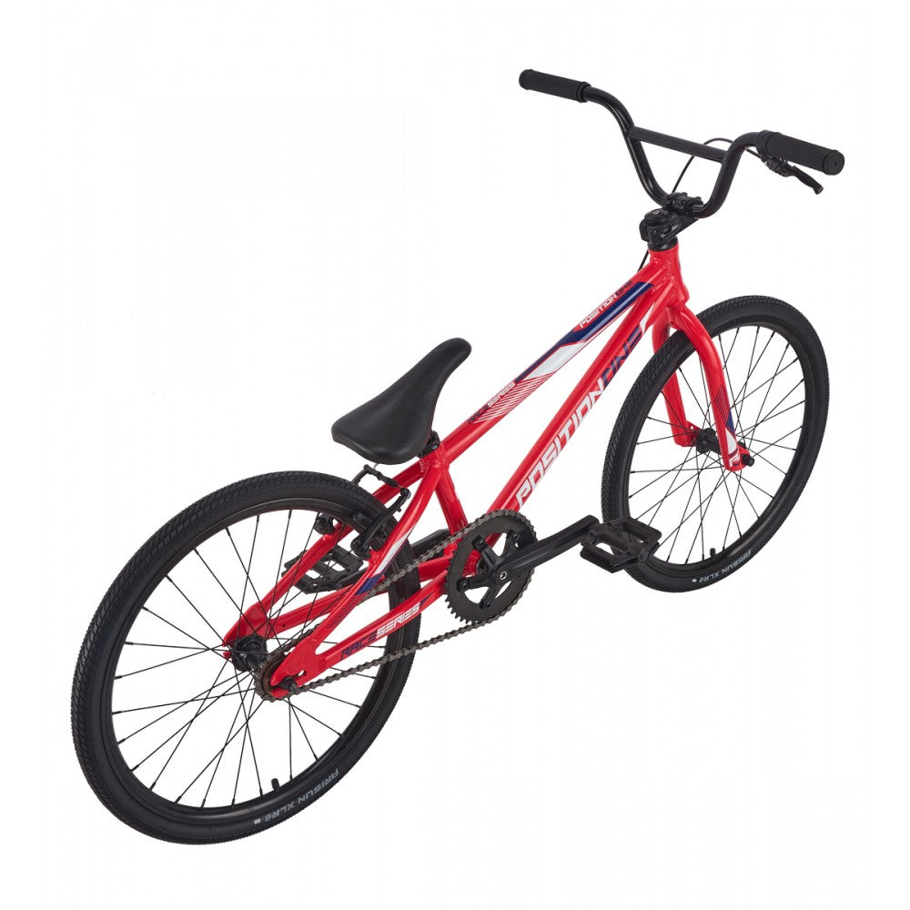 Red bicycle with black seat and tires on a white background