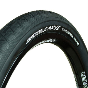 Close-up of a bicycle tire with 'Answer' branding on a white background