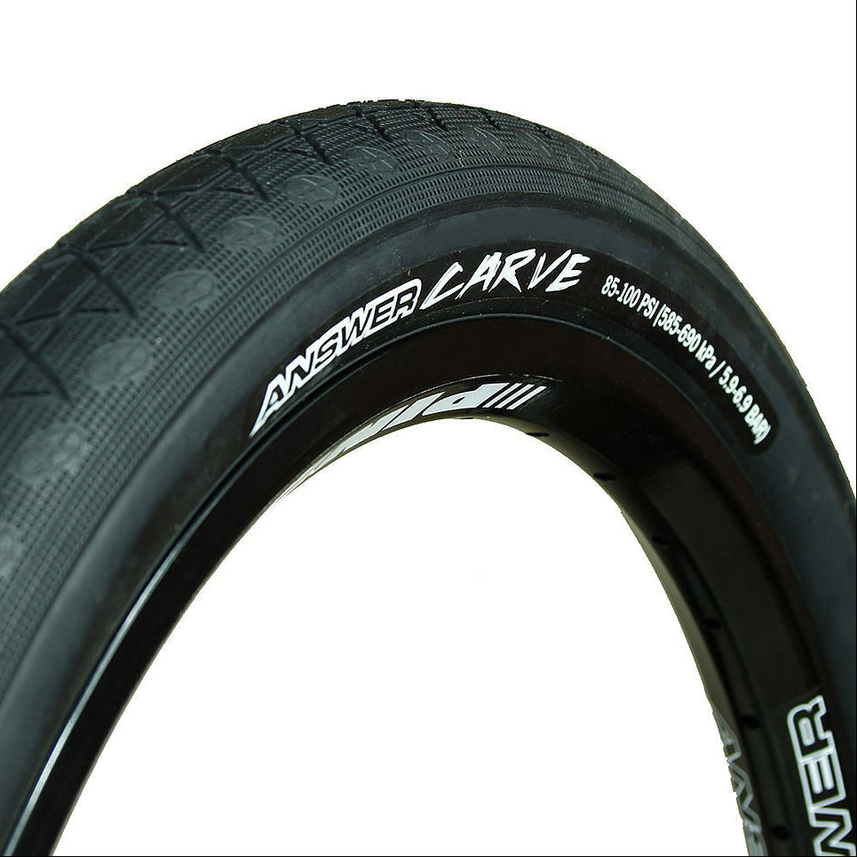 Close-up of a bicycle tire with 'Answer' branding on a white background
