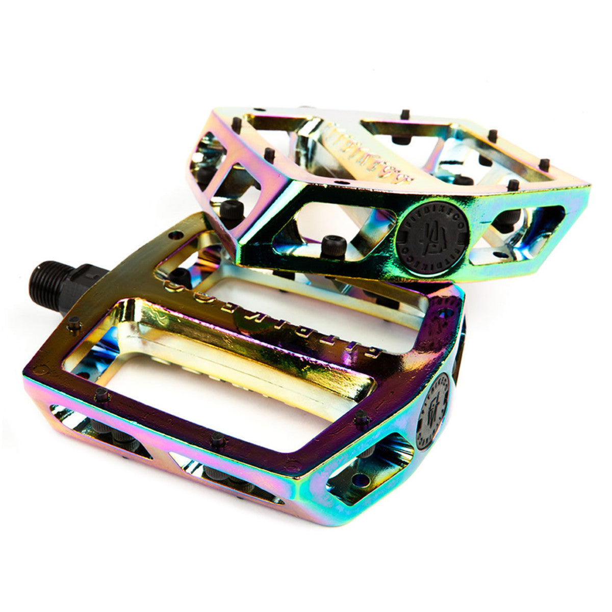 A pair of multicolored oil slick BMX platform pedals made of aluminum and chromoly, featuring a 9/16" spindle size and recessed service cap.