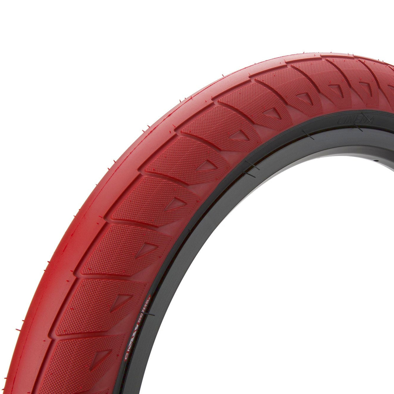 A red BMX tire with black sidewall, showing the tread pattern and sidewall design.